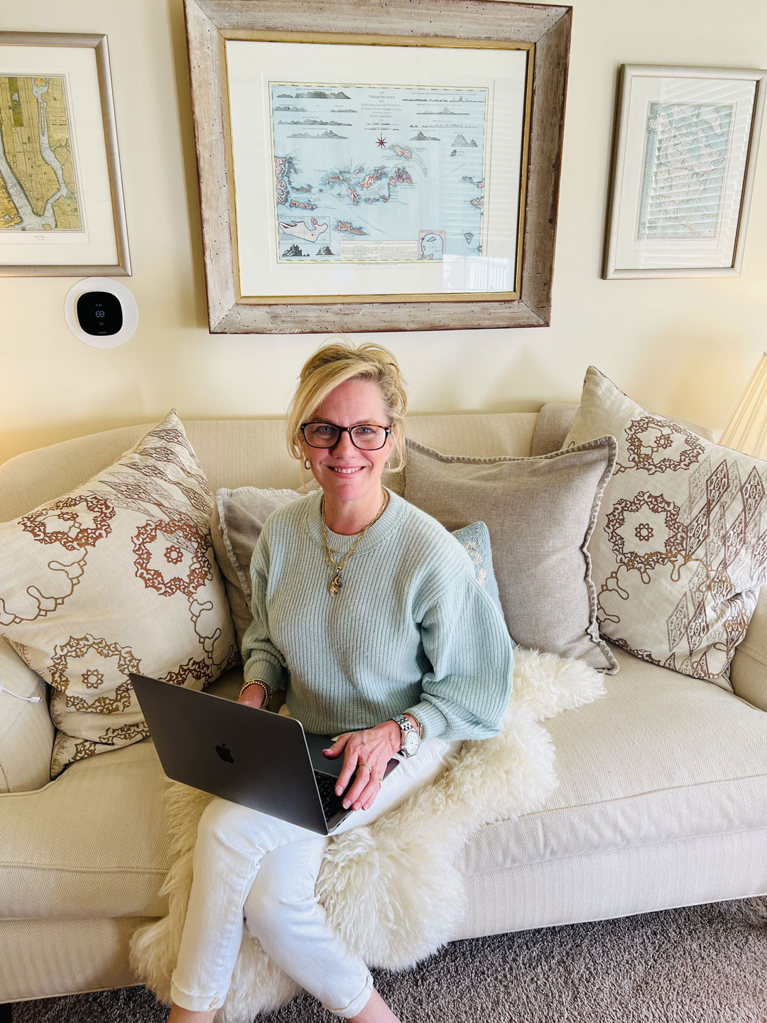 Colleen Van Houten Interior Designer with laptop working on couch