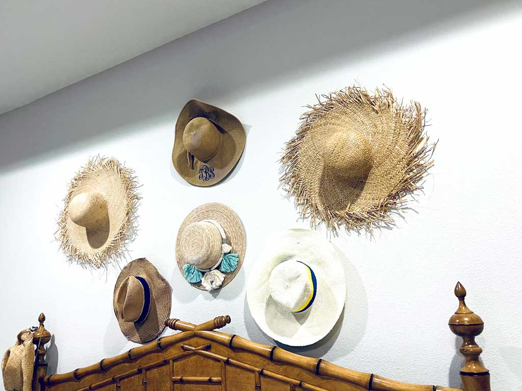 Various hats above bedpost arranged by Colleen Van Houten